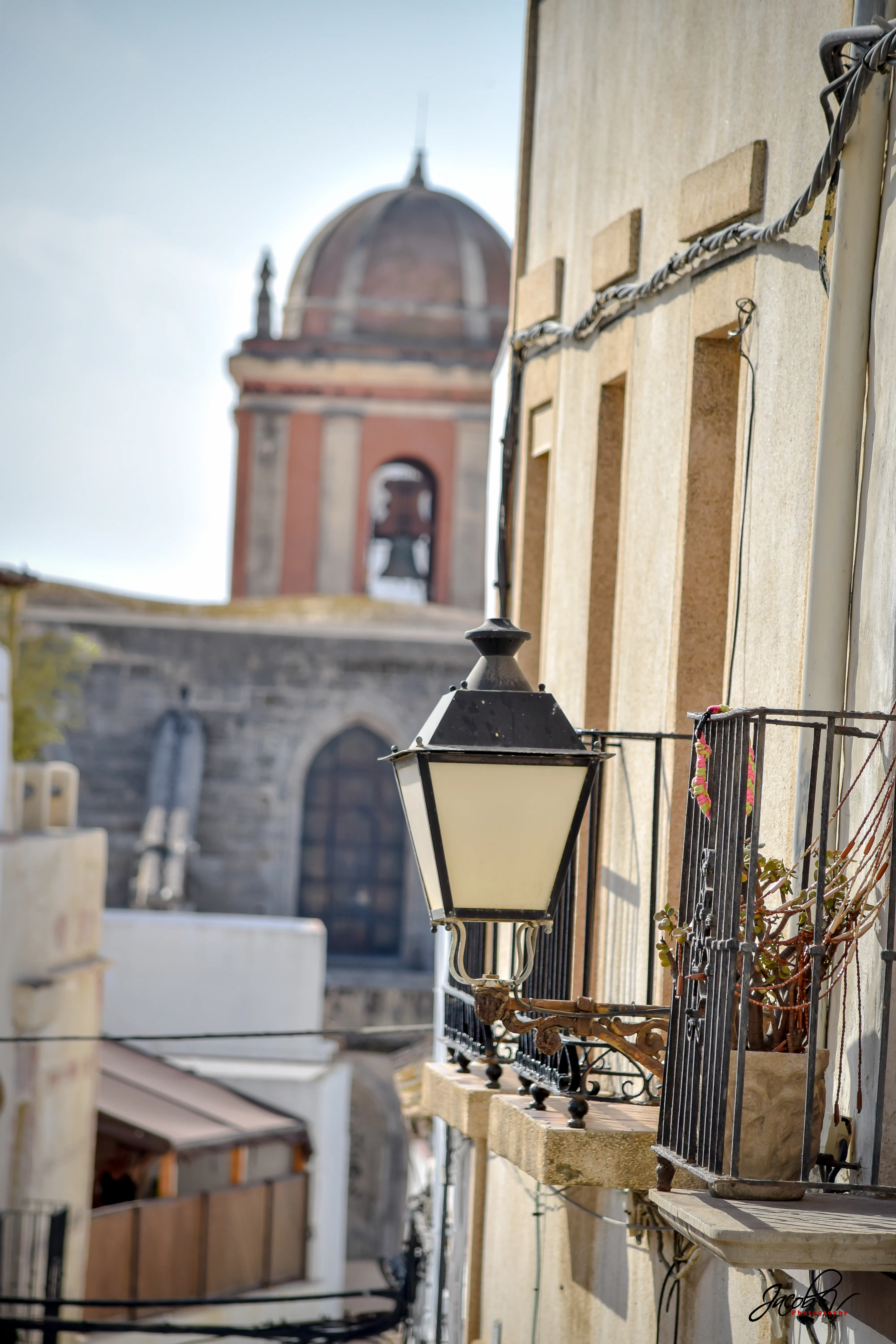 A lane in Tarifa old town with the church tower behind