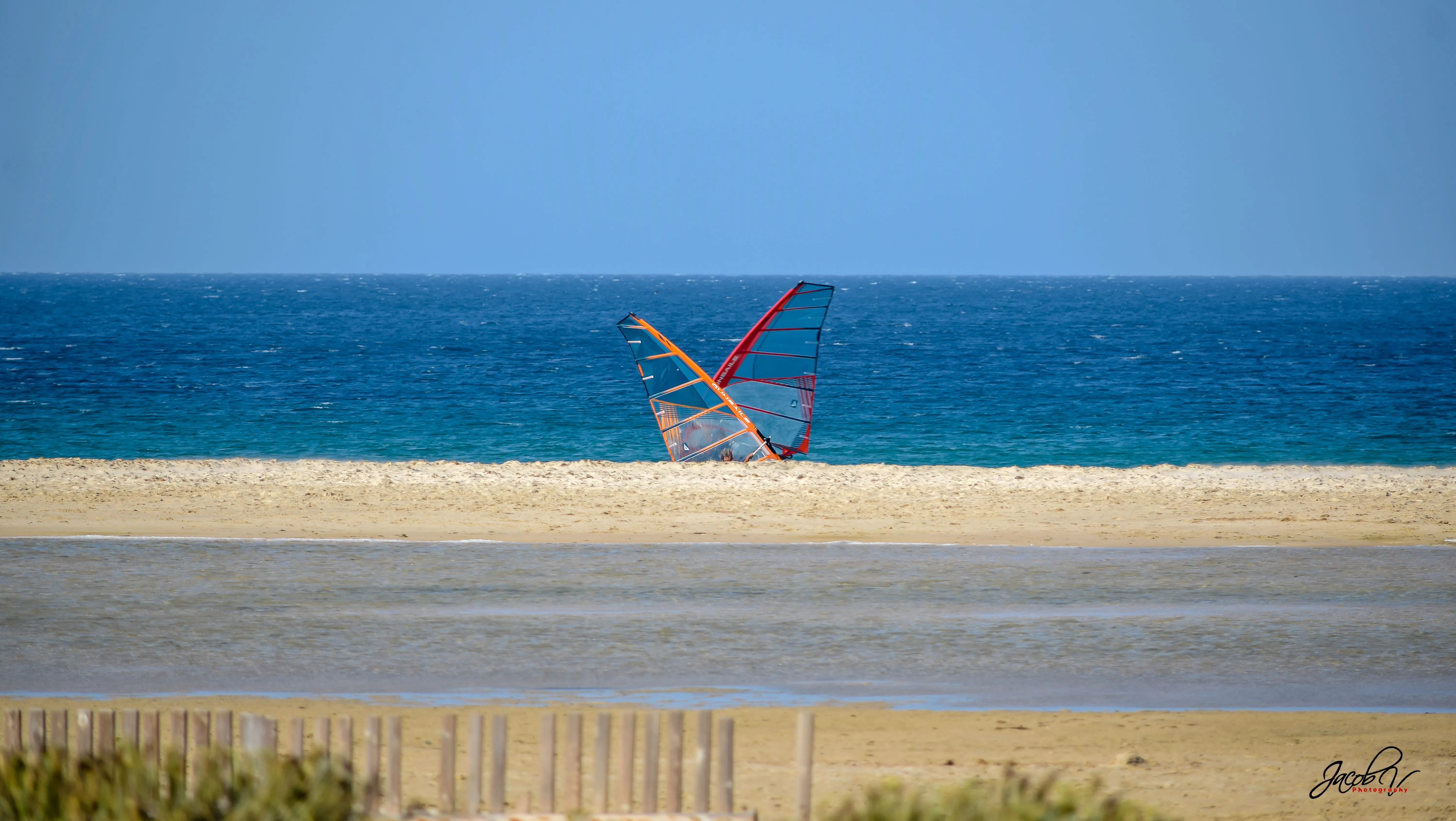 Windsurfers at the water's edge